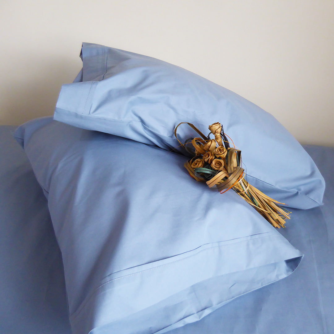 SleepFROG-blue-pillowcases-on-bed-with-flax-woven-flowers